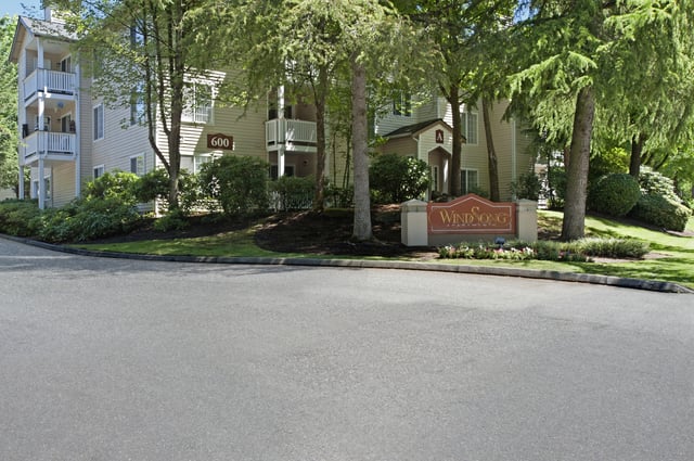 Windsong Apartments monument sign and building exterior.