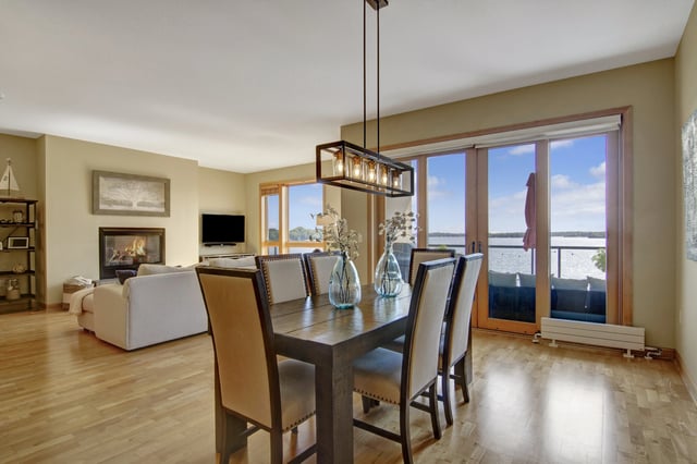 Dining room with a fireplace and a view of the water.