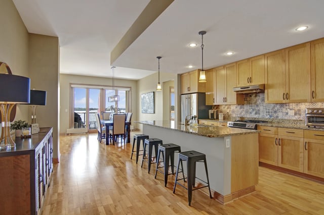Spacious kitchen and dining area with a large island and water views.