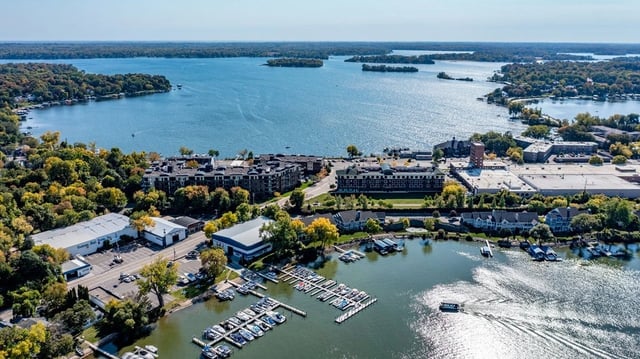 Aerial view of apartment buildings along a waterfront with a marina.