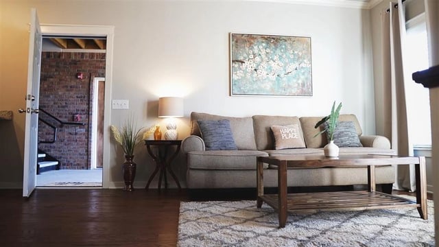 Living room with a sofa, coffee table, and artwork.