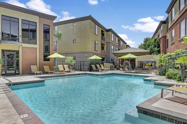 Swimming pool with lounge chairs and umbrellas