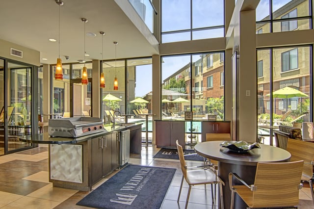 Outdoor kitchen and lounge area overlooking the pool.