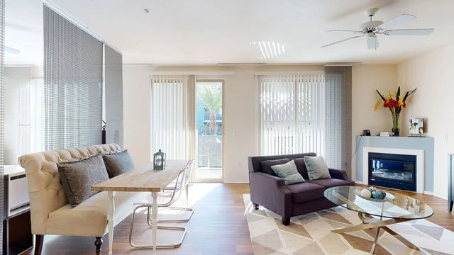 Living room and dining area with a fireplace.