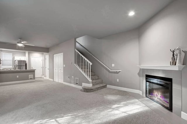 Living room with fireplace and open kitchen area