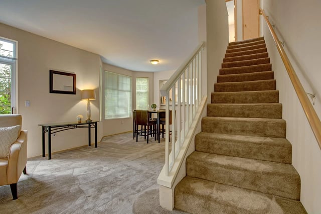 Interior view of a staircase and dining area.