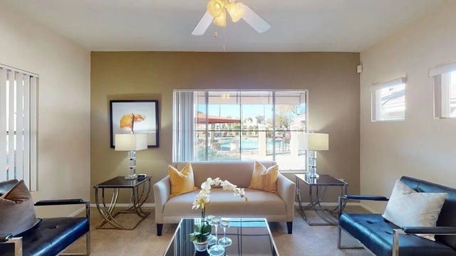 Living room with a view of the community pool.