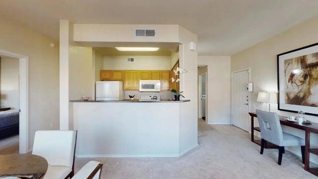 Kitchen and living area with desk and chair