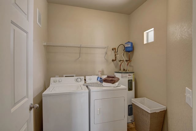 In-unit washer and dryer with a water heater and laundry basket