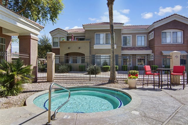 Hot tub in front of apartment buildings with outdoor seating