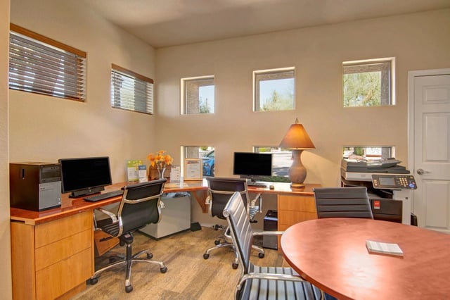Business center with computers, printer, and copier.