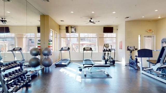 Fitness center with treadmills, elliptical, stationary bikes, and weight machines.