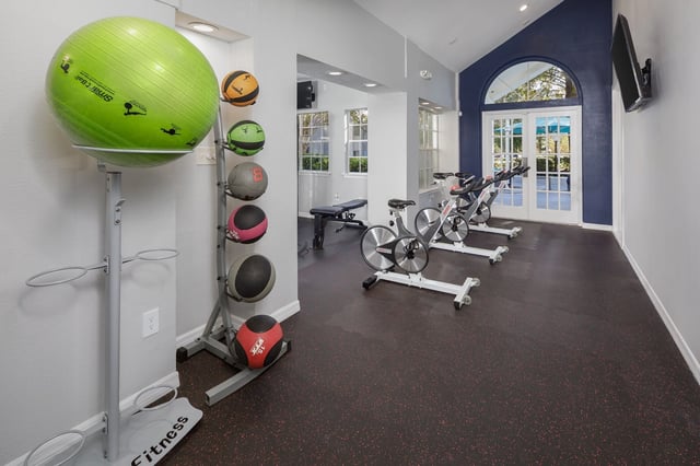 Gym with spin bikes, medicine balls, and a yoga ball.