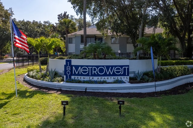 MetroWest Premier Apartments monument sign with American flag.