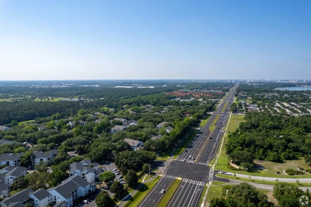 Aerial view of apartment buildings and a highway.