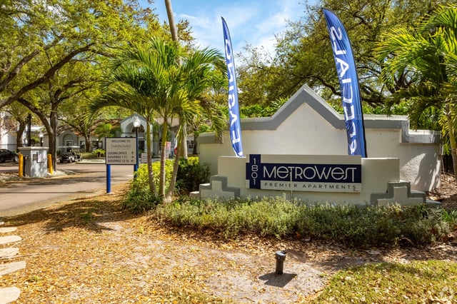 MetroWest Premier Apartments monument sign with blue flags.