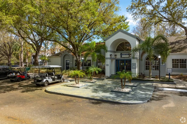Building entrance with golf carts parked nearby.