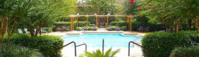 Swimming pool area with lounge chairs and tables
