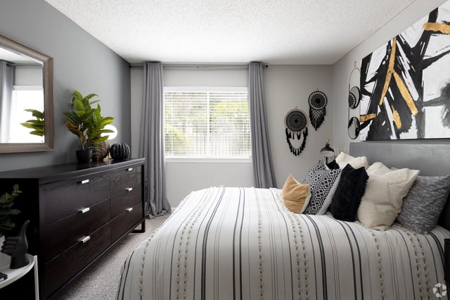 Boho-chic bedroom with a king-size bed and modern dresser.
