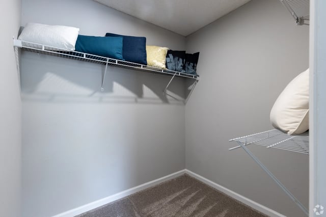 Empty closet with shelves and pillows.