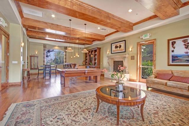 Community lounge with pool table, fireplace, and seating area.