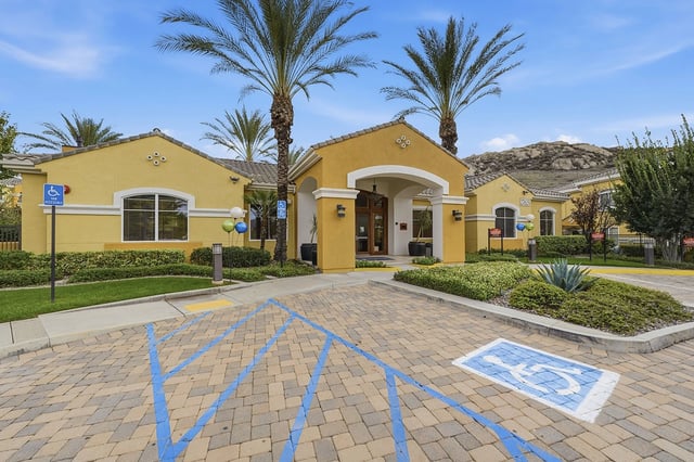 Entrance of apartment building with accessible parking spaces.