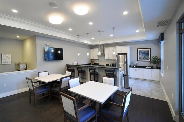 Community kitchen area with seating and bar stools