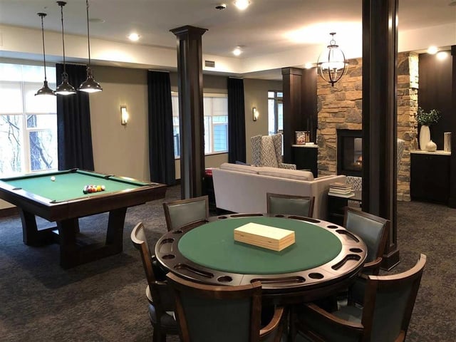 Community game room with pool table and card table.