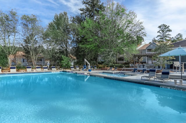 An inviting swimming pool with lounge chairs and umbrellas.