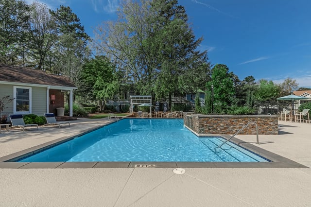 Outdoor swimming pool with lounge chairs and tables