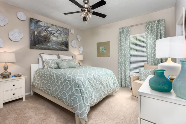 Cozy bedroom with a queen-size bed, nightstand, and window.