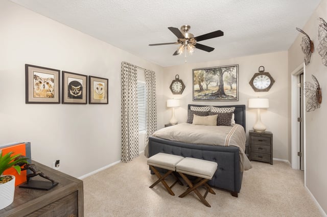 Bedroom with a king-size bed, nightstands, and owl-themed wall art.