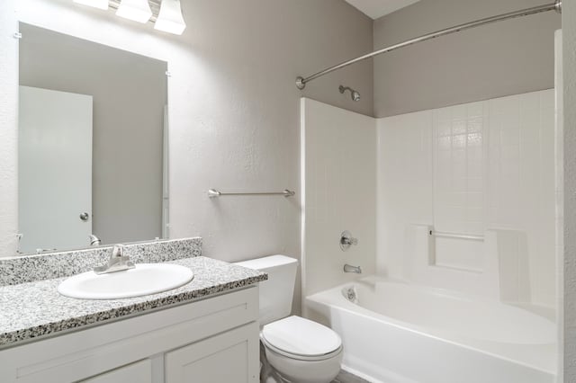 Bathroom vanity with granite countertop, sink, toilet, and bathtub with shower.