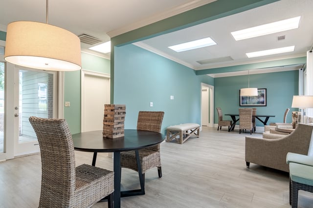 Community lounge area with table, chairs, and seating.