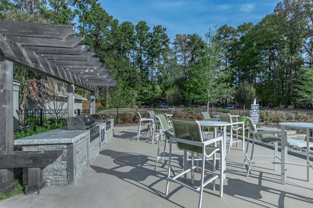 Outdoor grilling station with grills and seating area