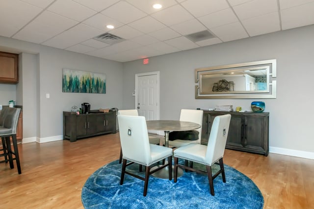 Clubhouse dining area with a round table and four chairs.