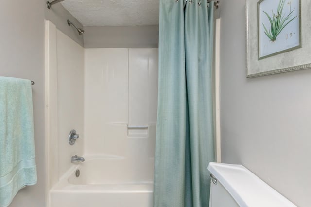 Bathroom with a bathtub, shower, and towel.