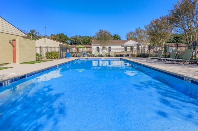 Outdoor swimming pool with lounge chairs and umbrellas