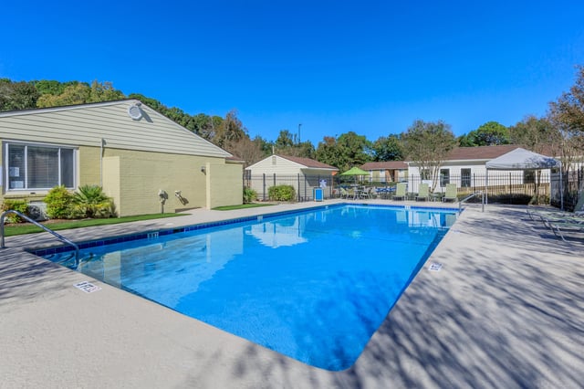 Swimming pool with lounge chairs and umbrellas