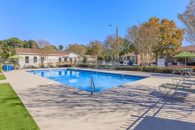 Outdoor swimming pool with lounge chairs and umbrellas