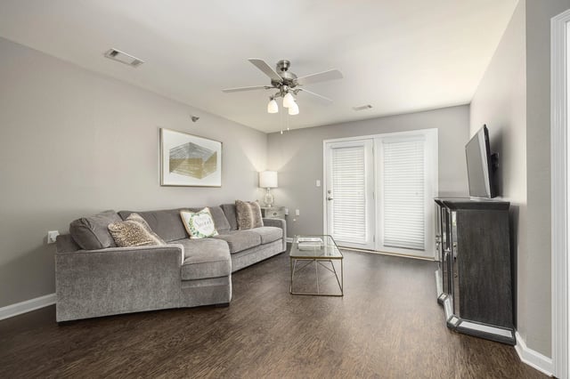 Living room with a sectional sofa, coffee table, and entertainment center.