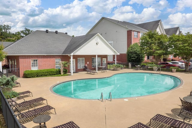 Swimming pool and lounge chairs outside apartment buildings