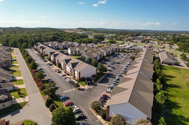 Aerial view of apartment buildings and parking lots.