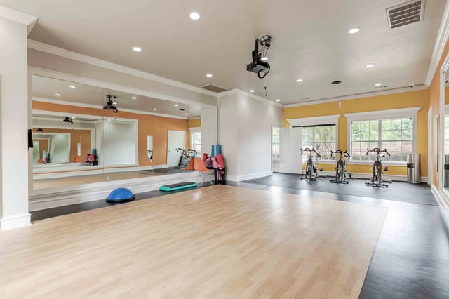 Fitness studio with spin bikes and mirrored wall