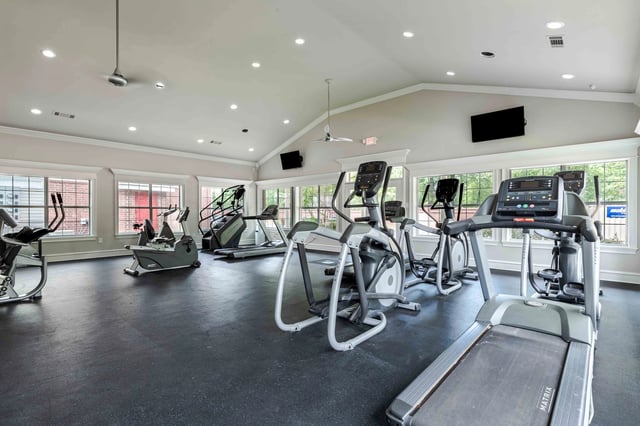 Fitness center with cardio machines including treadmills and ellipticals.