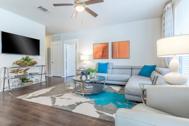 Living room with a large sectional sofa, coffee table, and TV.