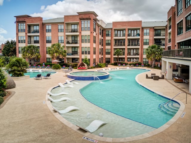 Resort-style swimming pool with tanning ledges and a spa.