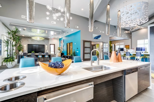 Modern apartment community lounge with kitchen island and seating