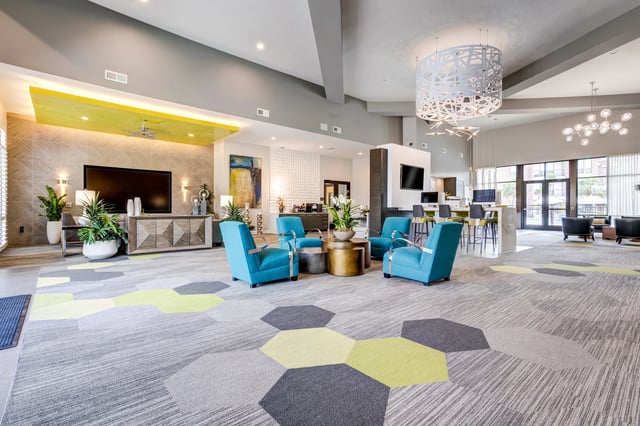Luxurious apartment community lounge with comfortable seating and modern decor.