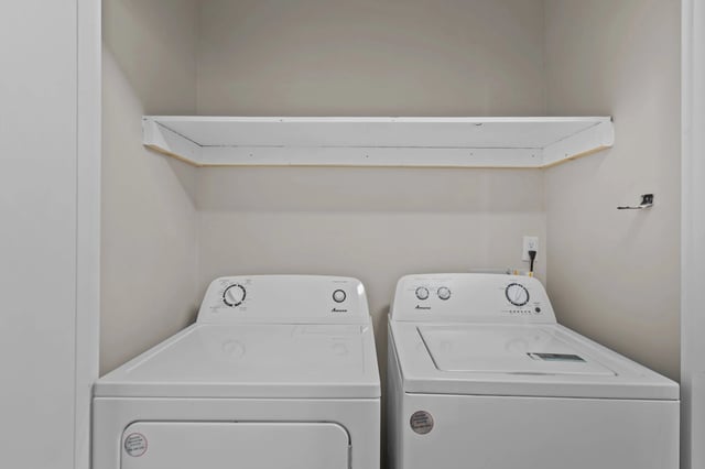 In-unit washer and dryer with a shelf above.